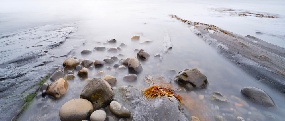 Photograph of pebbles on a beach at Kimmeridge, Dorset by Mark Asprey.